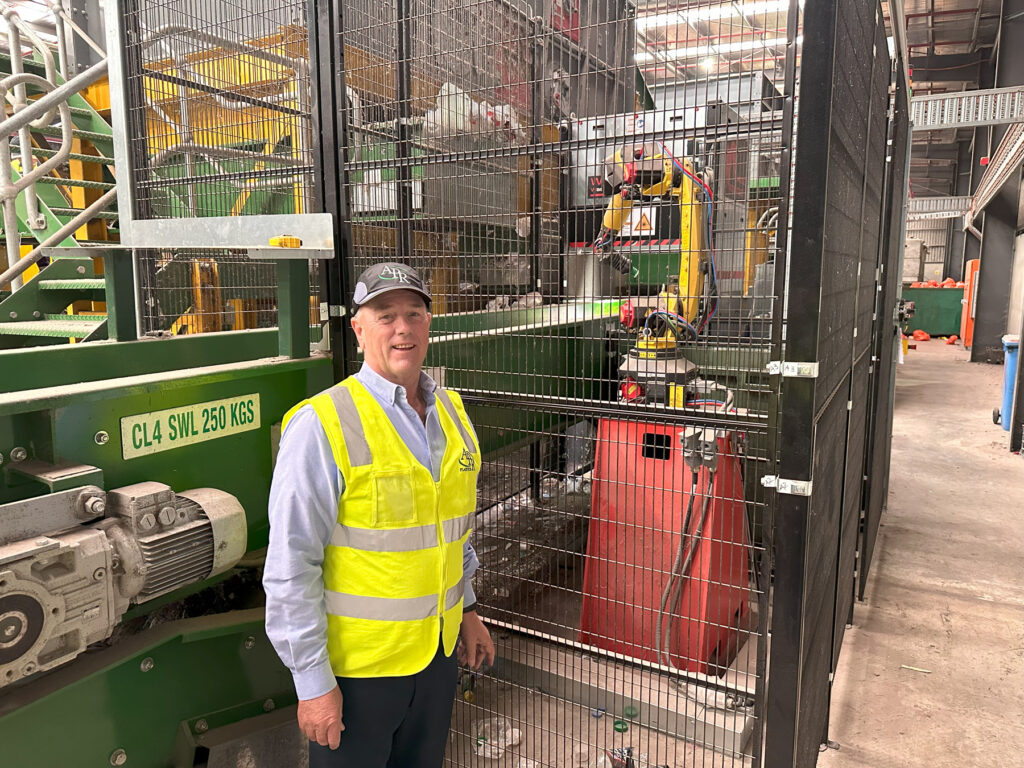 Darren Thorpe Managing Director of APR and the newly installed AI robot at APR s Materials Recovery Facility in Truganina Victoria