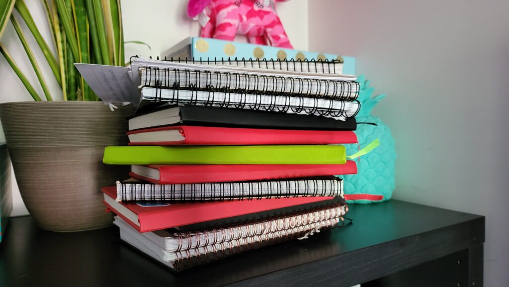 Pile of paper-based notebooks.