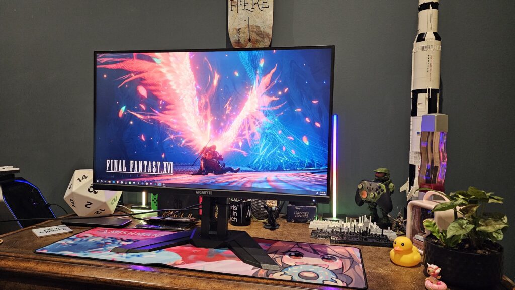 AORUS FI32U 4K monitor on the stand sitting on a table.
