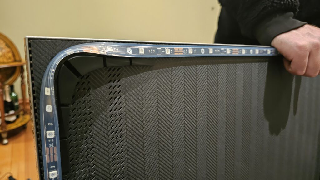 Nanoleaf 4D light shown wrapped around the corner bracket of the TV.