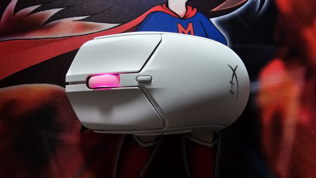 White HyperX Pulsefire Haste 2 mouse with a pink light on the center mouse wheel.