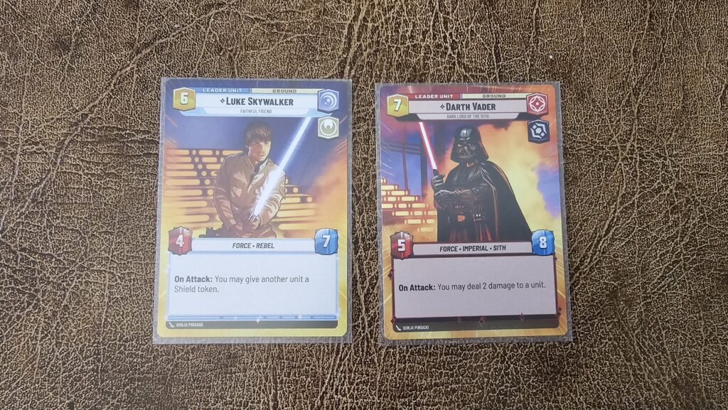 Luke Skywalker and Darth Vader leader cards. Each card has an ability.