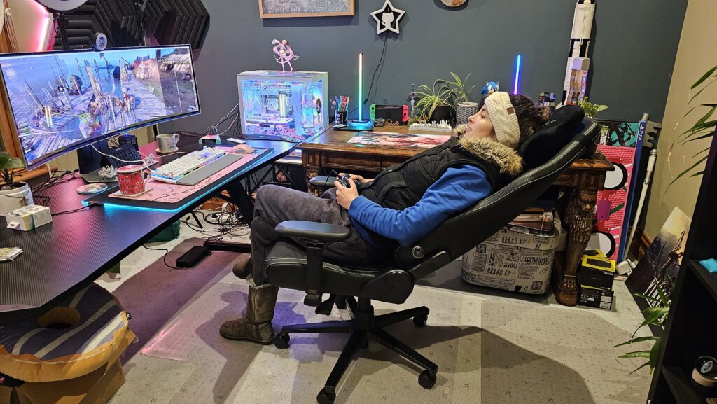 Me fully reclining in the chair playing games on the computer using the controller in my hands.