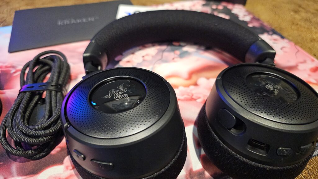 Showing headset with close up of the controls on the earcups.