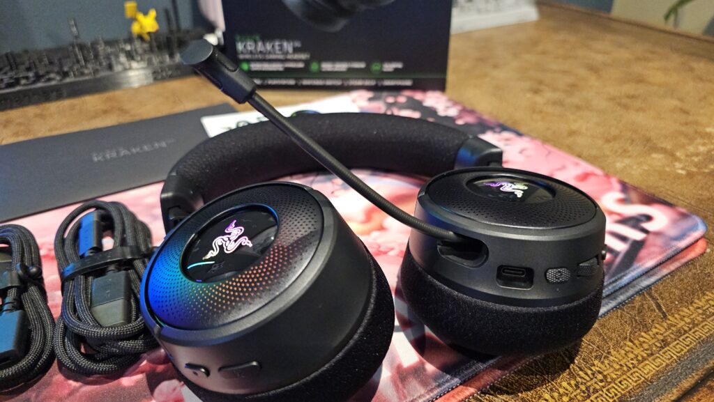 Close up with the RGB on the earcups and the retractable mic coming from the left side.