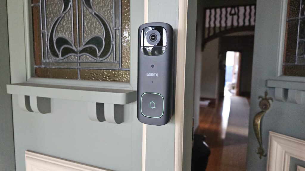 The doorbell is light up green indicating someone is in the camera view.